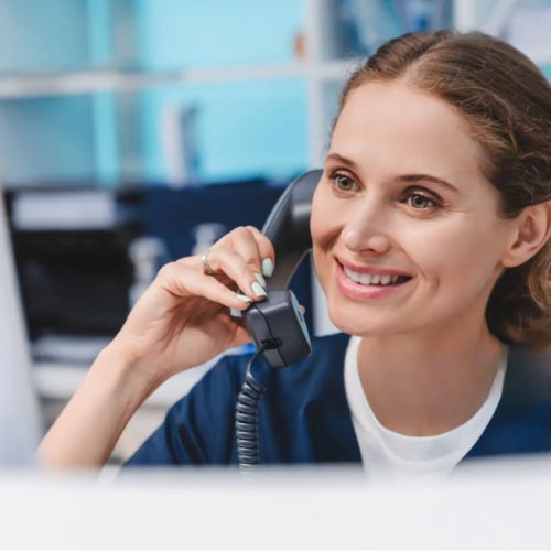 a female customer representative talking on phone with smiling expression